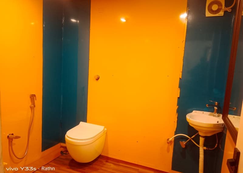 A boat house bathroom with a bright painted wall