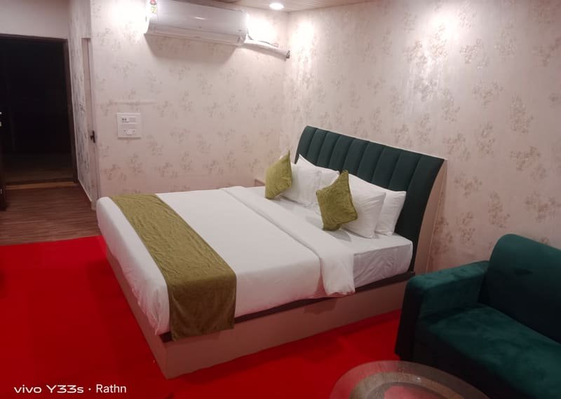 A boat house room with the bed made up beside the window