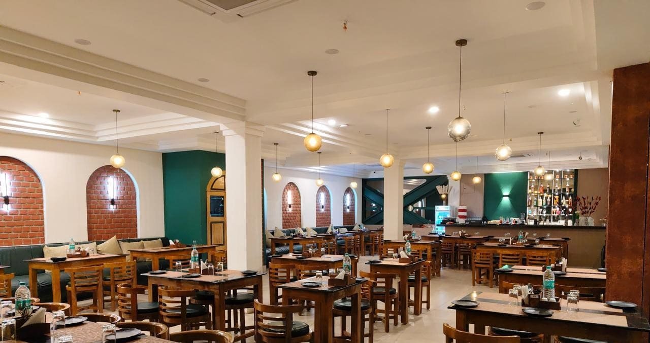 Laid tables and pendant lights inside Moti Mahal