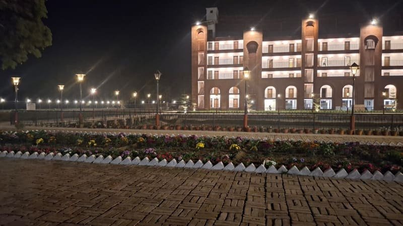 The resort lit above its lawn after dark