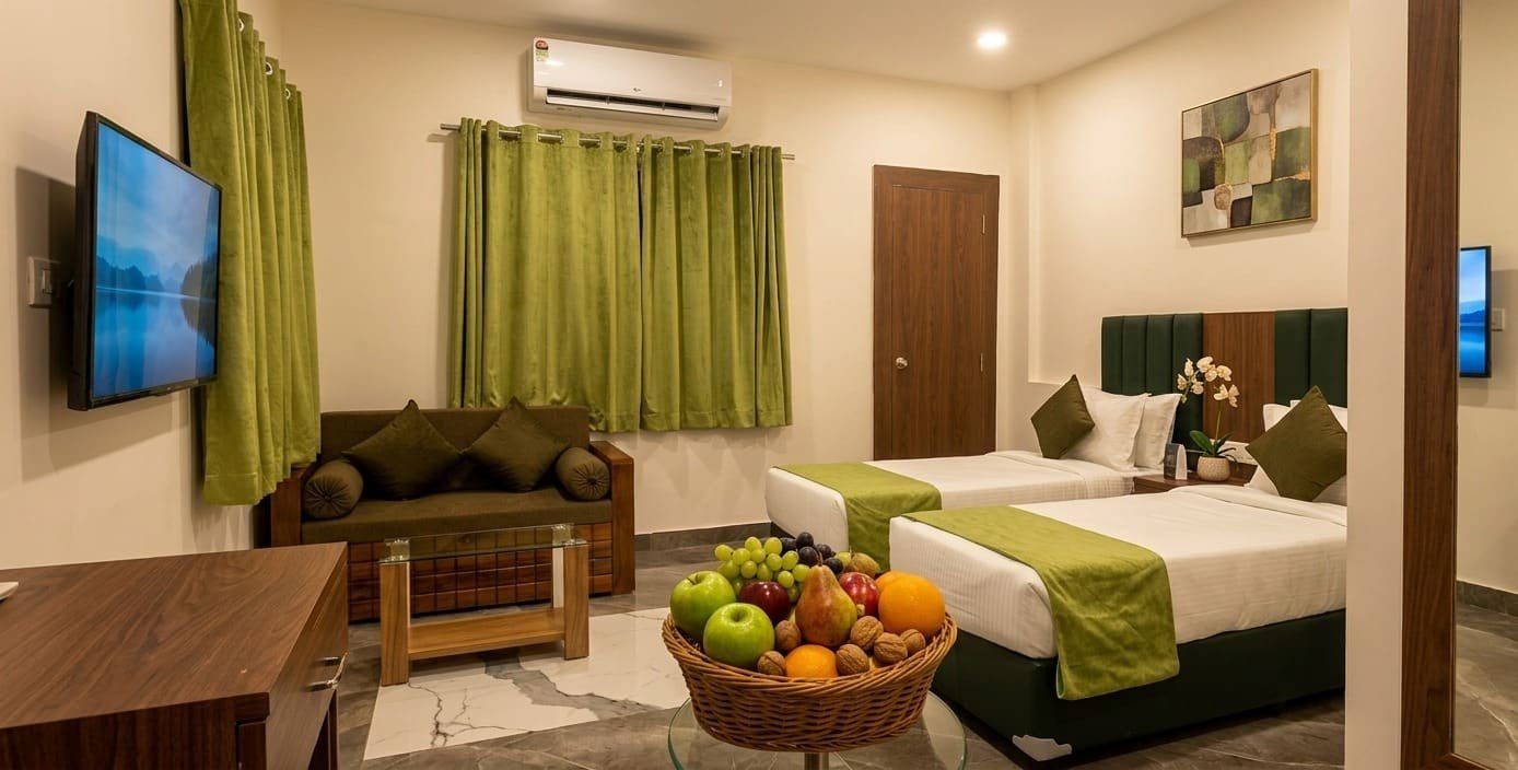 Suite interior with twin beds, sofa and a fruit basket